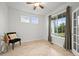 Bright bedroom features wood floors, a ceiling fan, and a view of trees at 42225 Kingsmill Cir, Elizabeth, CO 80107