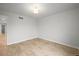 Bedroom features hardwood floors, neutral walls, and access to another room at 42225 Kingsmill Cir, Elizabeth, CO 80107