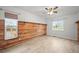 Light and bright bedroom with hardwood floors and rustic wood accent wall at 42225 Kingsmill Cir, Elizabeth, CO 80107