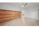 Well-lit bedroom with rustic wood wall, light hardwood floors, and neutral decor at 42225 Kingsmill Cir, Elizabeth, CO 80107