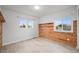 Bedroom features two windows, a rustic wood accent wall, and light hardwood floors at 42225 Kingsmill Cir, Elizabeth, CO 80107