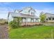 Well-maintained two-story home with brick accents, green lawn, and blue sky background at 42225 Kingsmill Cir, Elizabeth, CO 80107