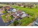 Aerial view of a home with lush landscaping, large driveway, and well-maintained lawn at 42225 Kingsmill Cir, Elizabeth, CO 80107