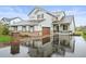 Two-story home with a brick-accented facade, covered porch, and wet driveway at 42225 Kingsmill Cir, Elizabeth, CO 80107