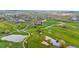 A picturesque golf course features winding paths, water hazards, and manicured greens for a serene recreational experience at 42225 Kingsmill Cir, Elizabeth, CO 80107
