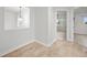 Hallway leads to another room with a lovely hanging light fixture and hardwood floors at 42225 Kingsmill Cir, Elizabeth, CO 80107