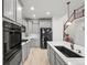 Beautiful kitchen features gray cabinets, stainless appliances, and a large center island at 42225 Kingsmill Cir, Elizabeth, CO 80107