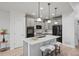 Stylish kitchen with modern appliances, pendant lights, and a central island with bar stool seating at 42225 Kingsmill Cir, Elizabeth, CO 80107