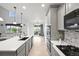 Modern kitchen with stainless appliances, stone counters, and seamless flow to the great room at 42225 Kingsmill Cir, Elizabeth, CO 80107