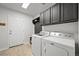 Functional laundry room featuring modern washer and dryer and ample storage at 42225 Kingsmill Cir, Elizabeth, CO 80107