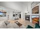 Spacious living room featuring a fireplace, island kitchen, and vaulted ceilings at 42225 Kingsmill Cir, Elizabeth, CO 80107