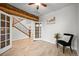 Inviting home office featuring French doors, wood accents, and light wood floors at 42225 Kingsmill Cir, Elizabeth, CO 80107
