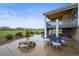 Covered patio with a fire pit and comfortable seating area at 42225 Kingsmill Cir, Elizabeth, CO 80107