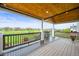 Covered patio boasts wood ceiling and views of the large grass-filled backyard at 42225 Kingsmill Cir, Elizabeth, CO 80107