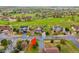 A well-kept suburban street showcases multiple houses alongside a lush green golf course at 42225 Kingsmill Cir, Elizabeth, CO 80107