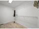 Bright walk-in closet featuring wire shelving, wood floors and a dress at 42225 Kingsmill Cir, Elizabeth, CO 80107