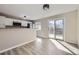 Modern kitchen open to the great room featuring stainless appliances and access to deck at 2522 W 100Th Ave, Federal Heights, CO 80260