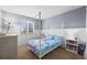 Bright bedroom with neutral walls, canopy bed, and a large window, creating a cozy and stylish space at 4797 Longs Peak St, Brighton, CO 80601