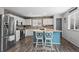 Stylish kitchen boasts stainless steel appliances, white cabinetry, and a bright breakfast bar with modern seating at 4797 Longs Peak St, Brighton, CO 80601