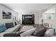 Comfortable living room with a plush sofa, dark wood floors, and a stylish entertainment center at 4797 Longs Peak St, Brighton, CO 80601