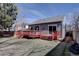 Expansive backyard featuring a well-maintained lawn, privacy fence, and a charming deck at 9659 Autumnwood Pl, Highlands Ranch, CO 80129