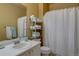 Cozy bathroom with white cabinets, tub and shower, and towel storage at 9659 Autumnwood Pl, Highlands Ranch, CO 80129