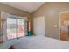 Bedroom features a sliding glass door to the backyard deck and neutral decor at 9659 Autumnwood Pl, Highlands Ranch, CO 80129