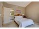 This bedroom features neutral decor and access to an ensuite bathroom at 9659 Autumnwood Pl, Highlands Ranch, CO 80129