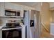 Modern kitchen featuring stainless steel appliances, electric cooktop, and plenty of storage at 9659 Autumnwood Pl, Highlands Ranch, CO 80129
