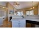 Well-lit kitchen features white cabinets, modern appliances, and a breakfast bar at 9659 Autumnwood Pl, Highlands Ranch, CO 80129