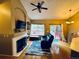 Comfortable living room with fireplace, large window, and access to an outdoor deck at 9659 Autumnwood Pl, Highlands Ranch, CO 80129