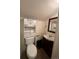 Compact half-bathroom with toilet, vanity, and storage cabinet at 3656 W 77Th Ave, Westminster, CO 80030