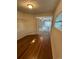 Bedroom showcasing hardwood floors, a window, and a hallway leading to other rooms in the home at 3656 W 77Th Ave, Westminster, CO 80030