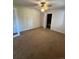 Bedroom featuring neutral carpet, ceiling fan, and an attached bathroom at 3656 W 77Th Ave, Westminster, CO 80030