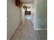 View of the hallway with light tile flooring leading to the kitchen area at 3656 W 77Th Ave, Westminster, CO 80030
