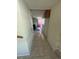 Long hallway with tiled floor, neutral paint, and several doorways to other rooms at 3656 W 77Th Ave, Westminster, CO 80030