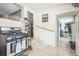 Functional kitchen area adjacent to stairs and hallway, tile flooring at 3656 W 77Th Ave, Westminster, CO 80030