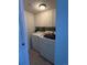 Functional laundry room featuring a washer, dryer, storage cabinets and tiled flooring at 3656 W 77Th Ave, Westminster, CO 80030