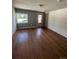 Cozy living room with hardwood floors and natural light streaming through a large window at 3656 W 77Th Ave, Westminster, CO 80030