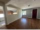 Inviting living room featuring gleaming hardwood floors and a view into the connected kitchen area at 3656 W 77Th Ave, Westminster, CO 80030