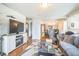 Cozy living room with hardwood floors, fireplace, and open access to the dining area at 3656 W 77Th Ave, Westminster, CO 80030