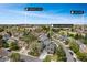 Aerial view showcases house in a neighborhood near a lake and community church at 17595 E Wesley Pl, Aurora, CO 80013