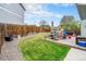 Backyard featuring a grass lawn, patio with seating, and playset at 17595 E Wesley Pl, Aurora, CO 80013