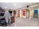 Versatile basement space, featuring carpeting, neutral walls, desk area, storage closet, and staircase at 17595 E Wesley Pl, Aurora, CO 80013