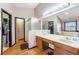 Bathroom with double sinks, a glass shower, hardwood floors, and a separate tub at 17595 E Wesley Pl, Aurora, CO 80013