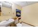 Compact powder room featuring tiled floors and a decorative Denver Broncos towel at 17595 E Wesley Pl, Aurora, CO 80013