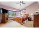 Inviting bedroom featuring cozy carpet, a large window, and a calming color palette at 17595 E Wesley Pl, Aurora, CO 80013