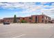 The brick building has ample parking and is surrounded by lush trees that provide privacy and shade at 17595 E Wesley Pl, Aurora, CO 80013