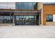 The Central Recreation Center entrance is beautifully designed with modern architecture, stone, and wooden beam accents at 17595 E Wesley Pl, Aurora, CO 80013