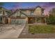 Charming two-story home featuring a brick facade, well-manicured lawn, and inviting curb appeal at 17595 E Wesley Pl, Aurora, CO 80013